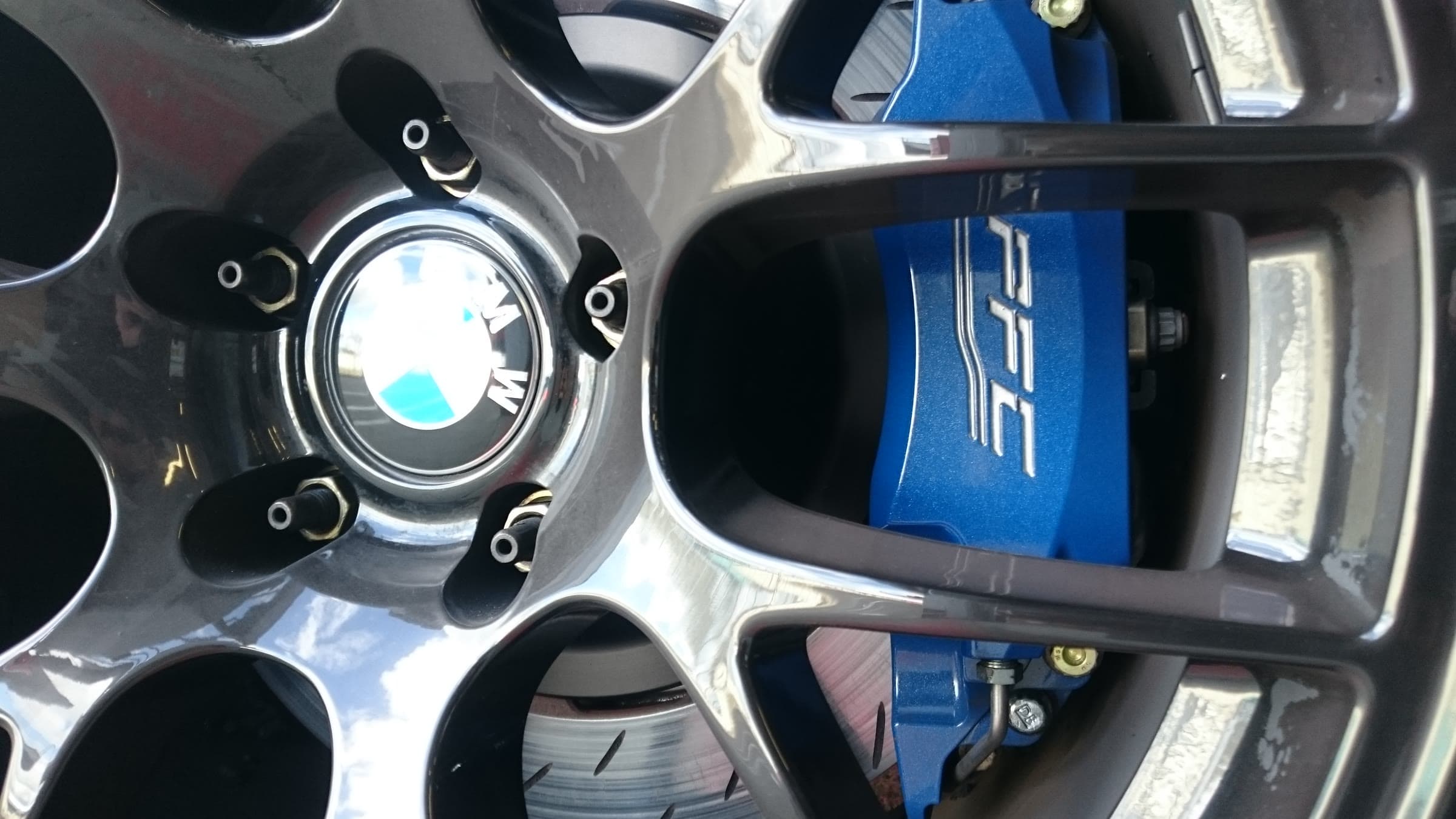 A BMW wheel with a blue PFC brake calliper