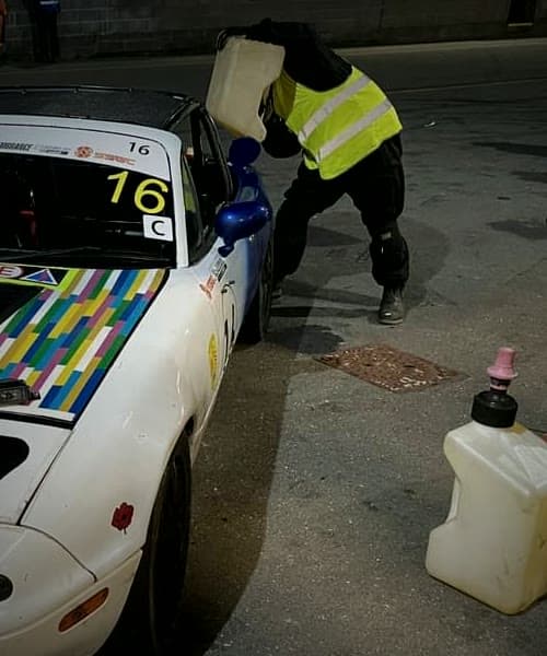 MX5 number 16 refuelled in the pit lane at night, Race of Remembrance