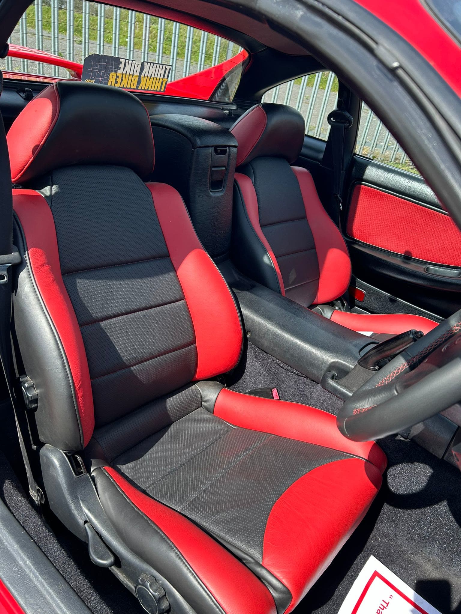 The re-trimmed red and black interior of a restored Toyota MR2